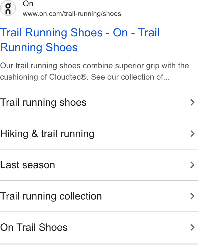 An On search ad in the Ads Transparency Center for trail running shoes with five sitelinks below it