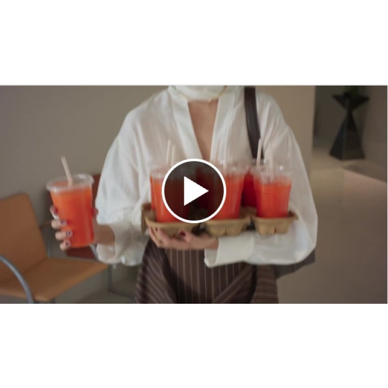 A HubSpot LinkedIn video ad thumbnail showing a person carrying a tray of drinks