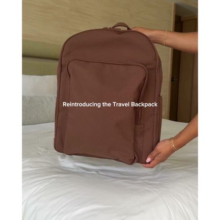 A UGC ad showing hands placing a travel backpack on a bed