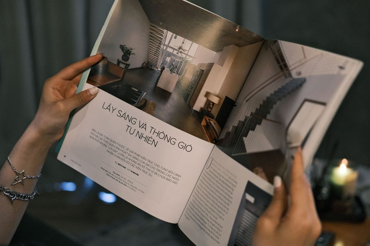 Two hands hold a magazine open on a long feature with a big photo and a short headline: a paid post uses the same layout as the reporting around it