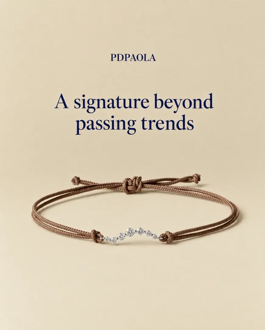 A static ad Selzee made for PDPAOLA: a brown cord bracelet under the serif line A signature beyond passing trends