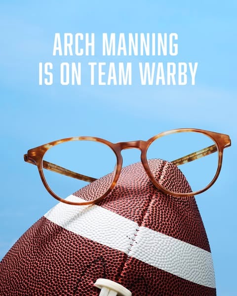 An ad by Warby Parker in Meta's Ad Library: tortoiseshell glasses rest on an American football under the words Arch Manning is on Team Warby
