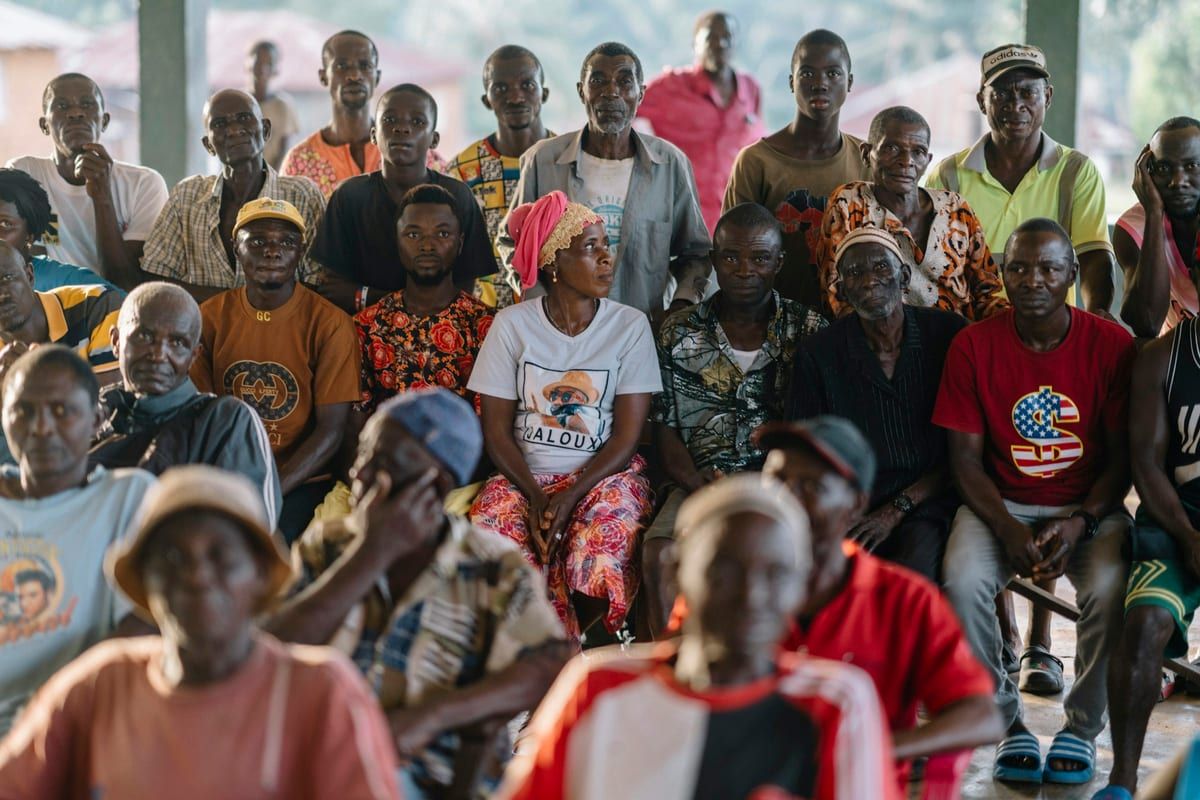 A large community gathering seated close together: a Facebook Group works like a meeting where the members do most of the talking