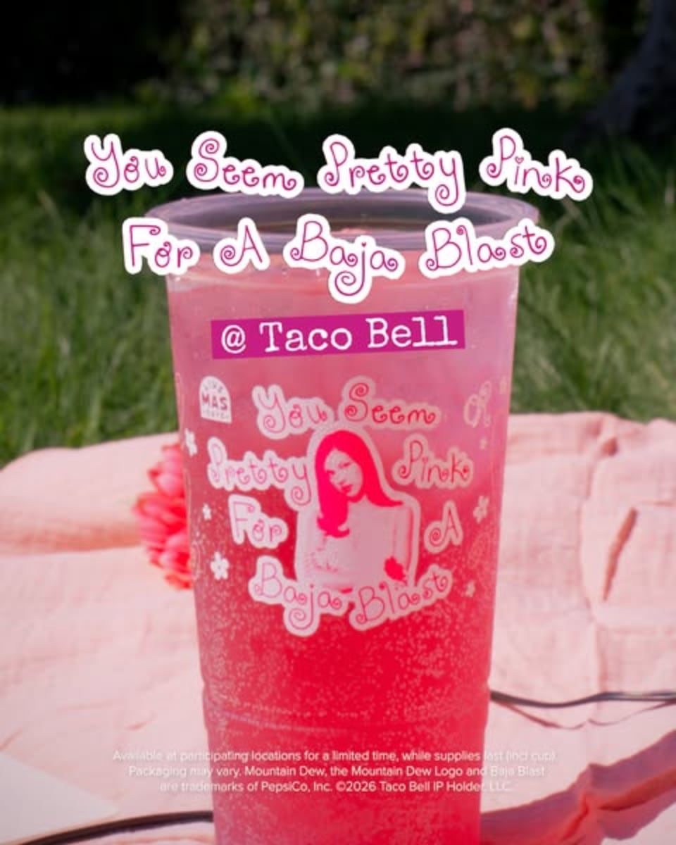 An ad by Taco Bell in the Meta Ad Library: a pink drink cup on a picnic blanket under the words You Seem Pretty Pink For A Baja Blast