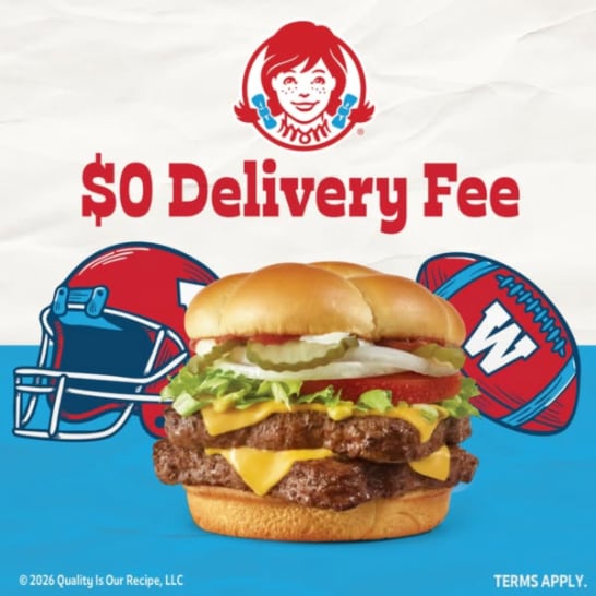 An ad by Wendy's in the Meta Ad Library: $0 Delivery Fee in red over a double cheeseburger between a football helmet and a football