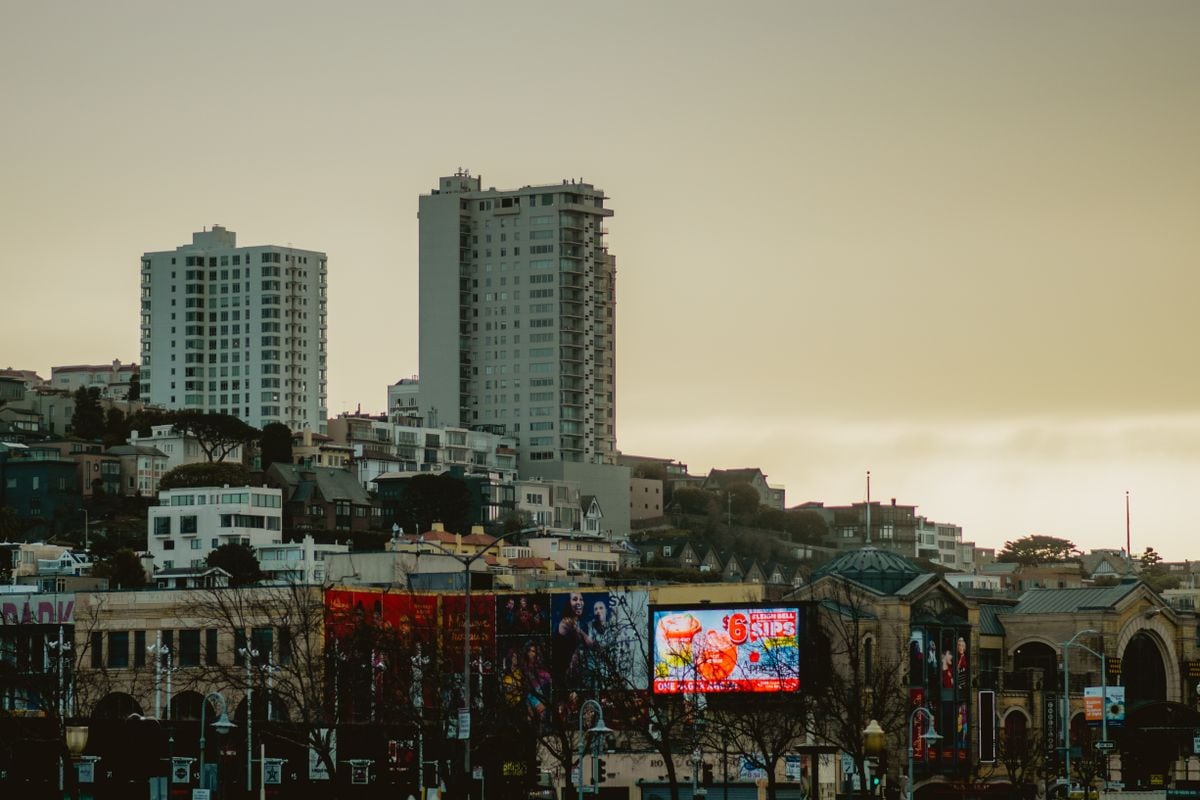 Billboards glowing over a city street at dusk: a line built on one number from your own data reads in the second a passer-by gives it