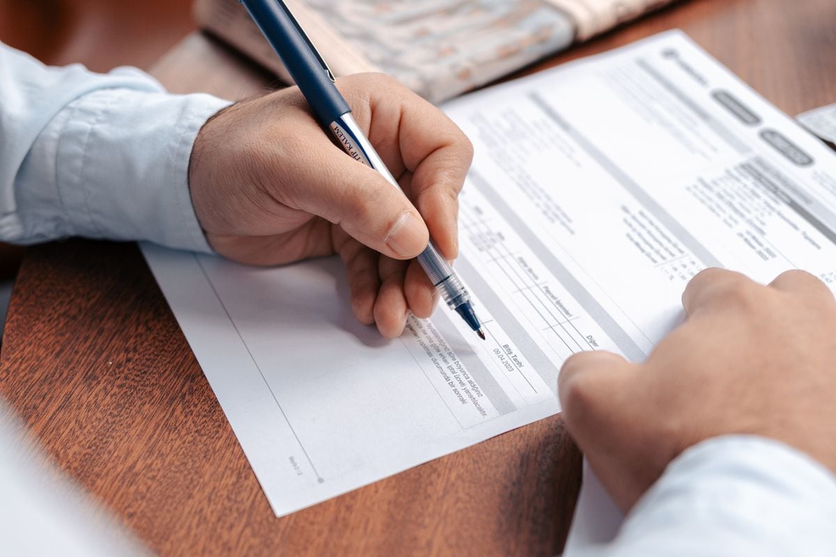 A hand marking up printed copy with a pen: the five-point check works best on a printout, one line at a time