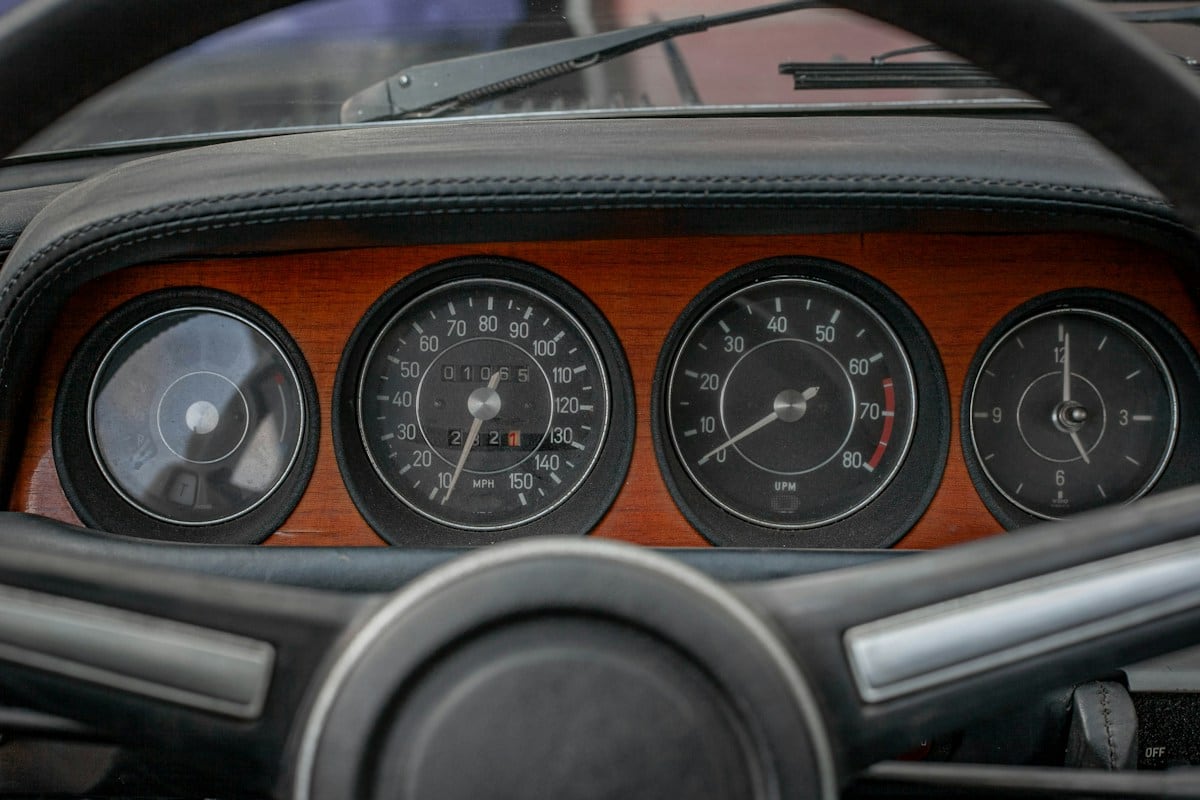 The wooden dashboard and round gauges of a vintage car: the kind of checkable detail the Rolls-Royce headline used instead of the word quiet