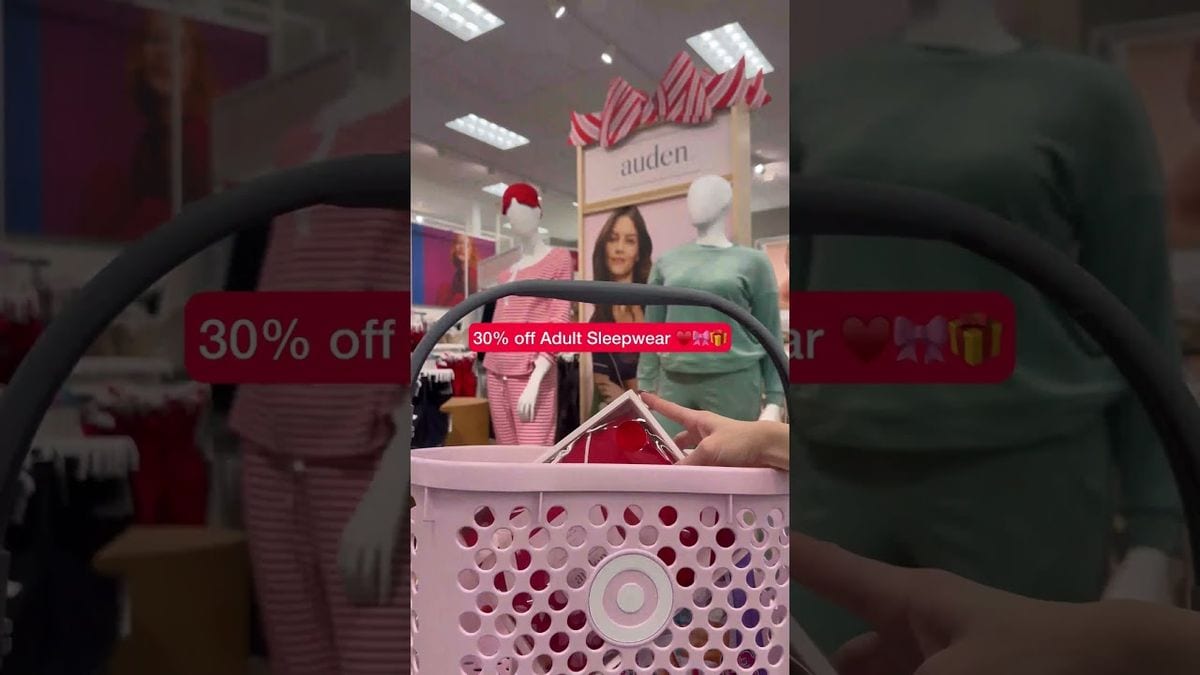 A frame from Target's 2024 Black Friday Deals Edition video: a pink Target basket in a store aisle, with a red sticker reading 30% off Adult Sleepwear over the shot