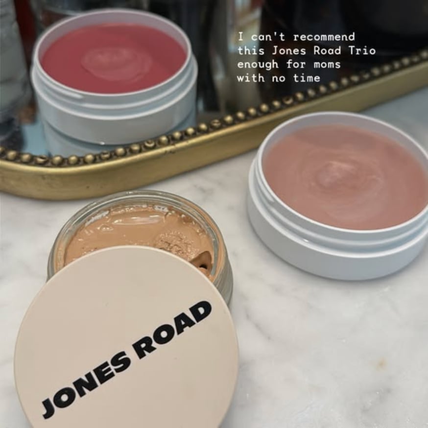 An ad by Jones Road in the Meta Ad Library: a phone photo of three makeup pots on marble with the words I can't recommend this Jones Road Trio enough for moms with no time