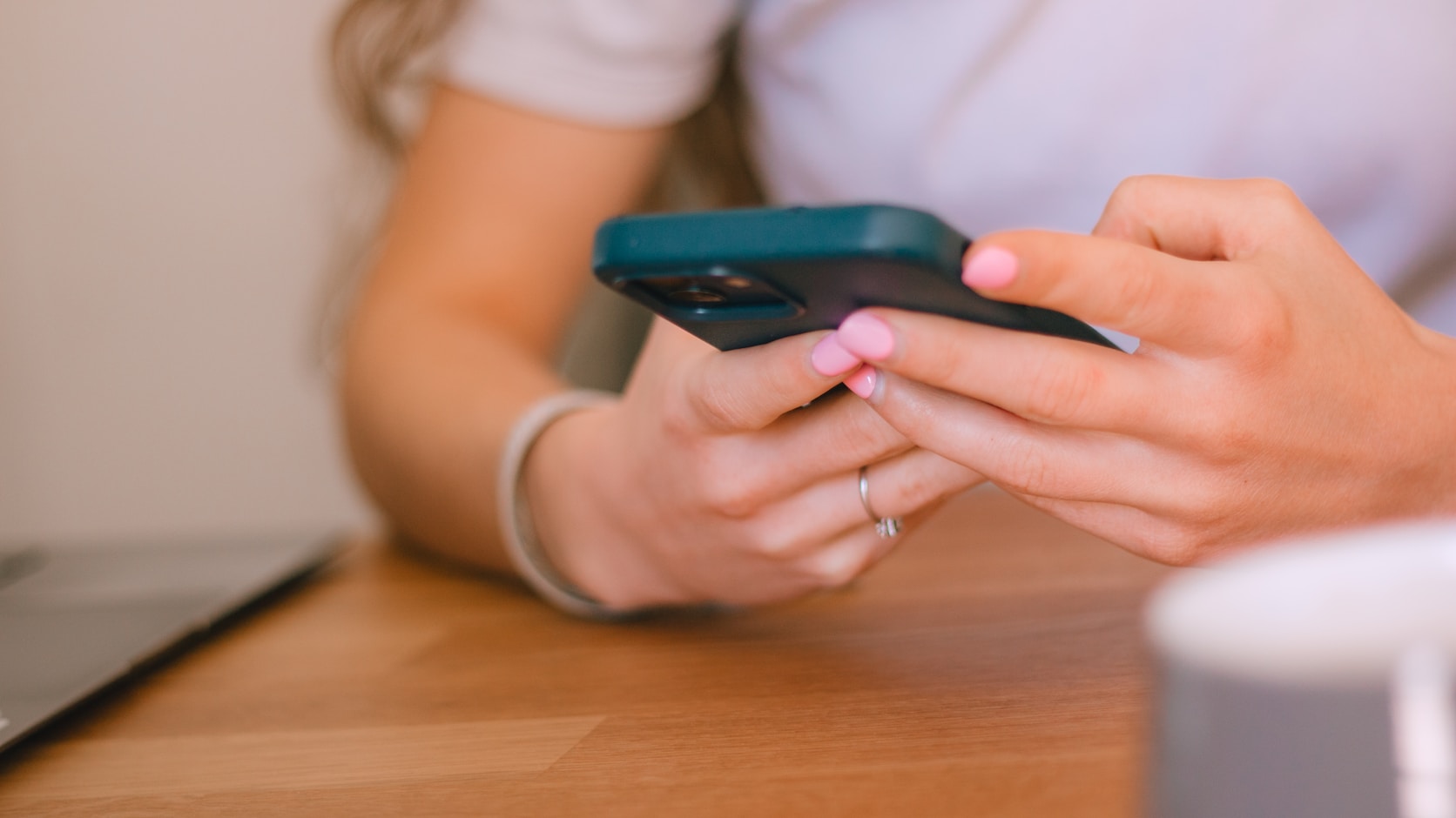 Hands holding a phone, close, mid-read