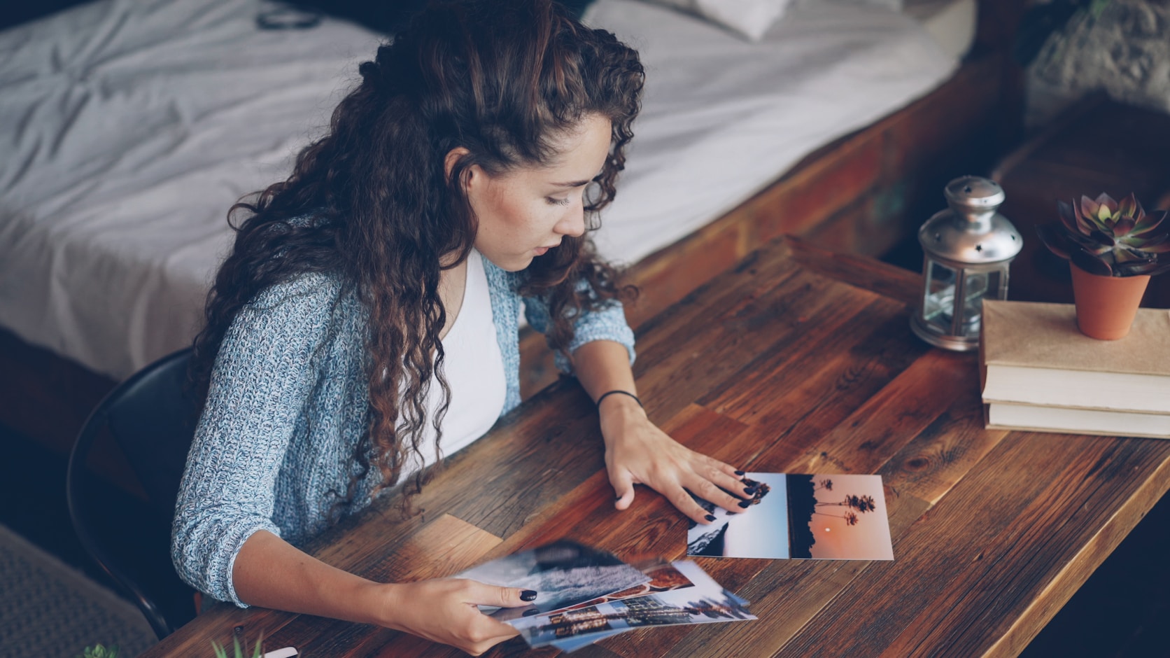 Someone laying printed photographs out on a table