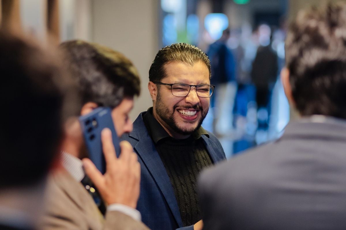 Two professionals laughing during a conversation at a networking event: retail buyers, suppliers and investors are the LinkedIn audience of a consumer brand