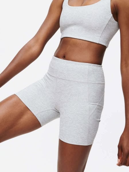 An ad by Outdoor Voices in Meta's Ad Library: Your new Doing Things uniform, made to move with you, over a model in gray shorts and a matching crop top