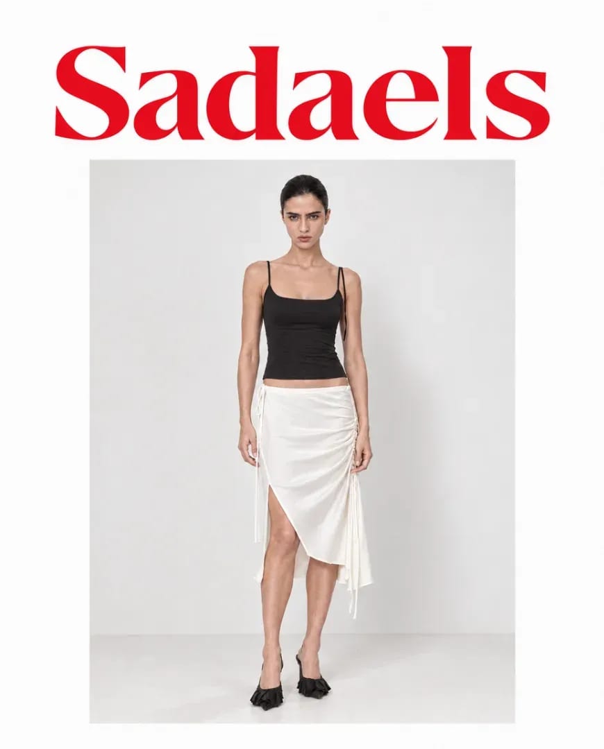 A Selzee-made ad for Sadaels: a model in a black top and a white draped skirt on a plain background, a clean product slide for a TikTok lookbook