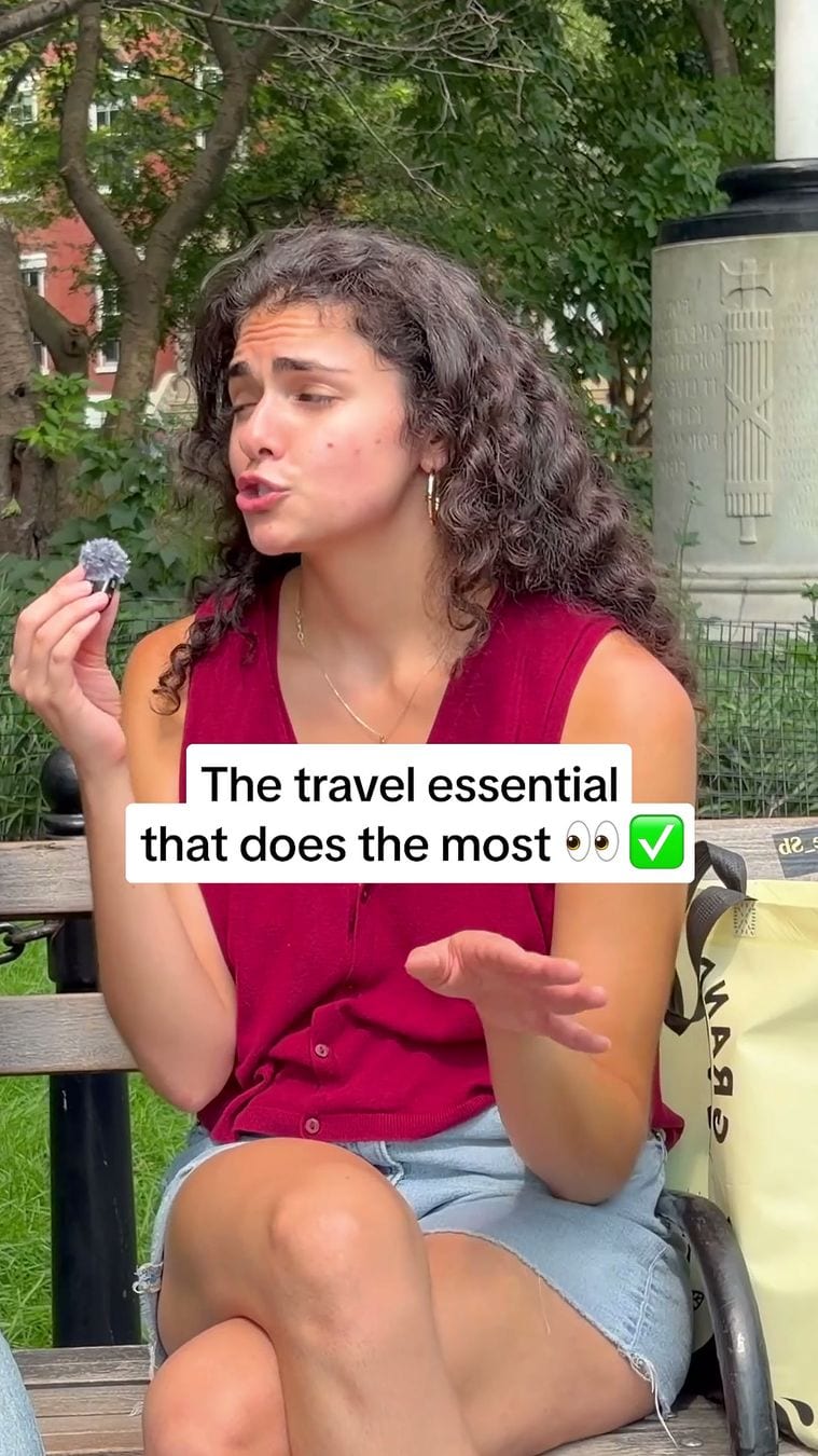 The opening frame of a Liquid I.V. video ad in Meta's Ad Library: a woman with a microphone on a leafy street under the caption The travel essential that does the most