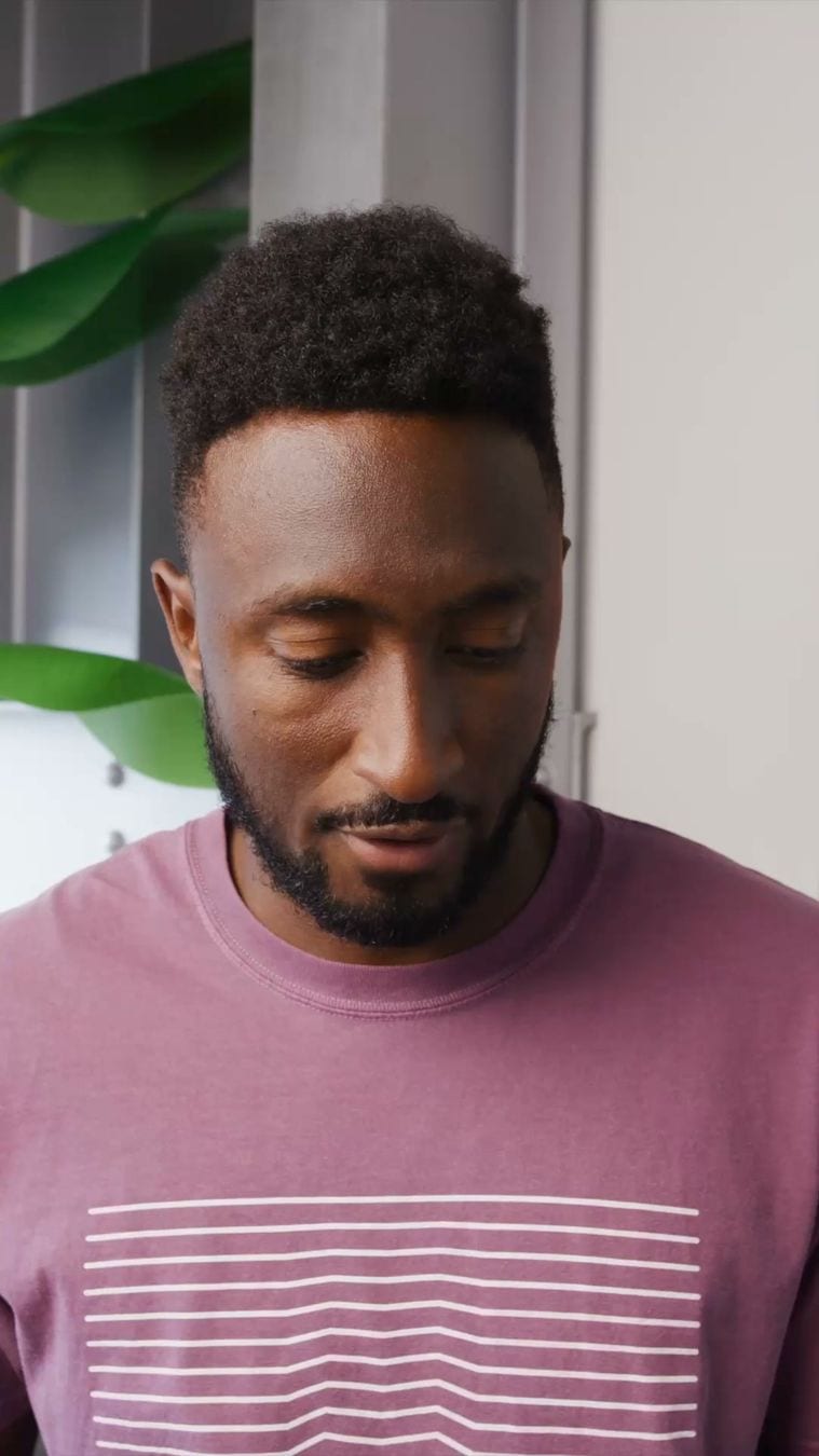 The opening frame of a partnership video ad from Marques Brownlee with The Ridge in Meta's Ad Library: he looks down at a product in front of a grey wall