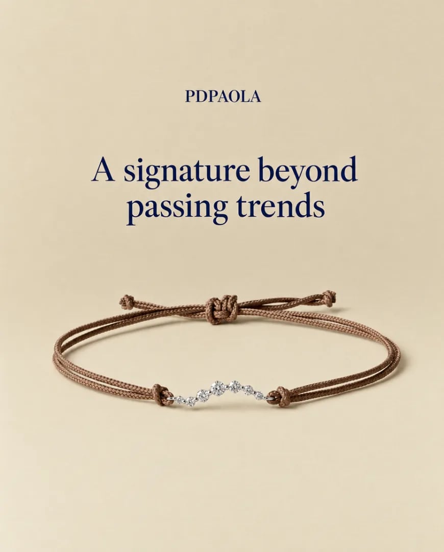 A static ad Selzee made for PDPAOLA: a brown cord bracelet with small diamonds on a beige background, under A signature beyond passing trends