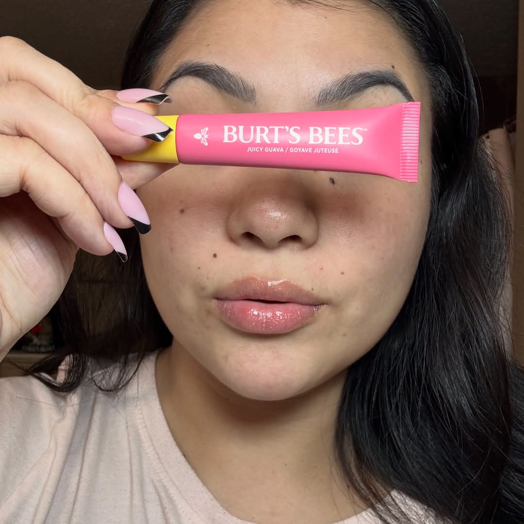 A creator selfie on Instagram holding a pink Burt's Bees lip balm, posted as gifted by Burt's Bees
