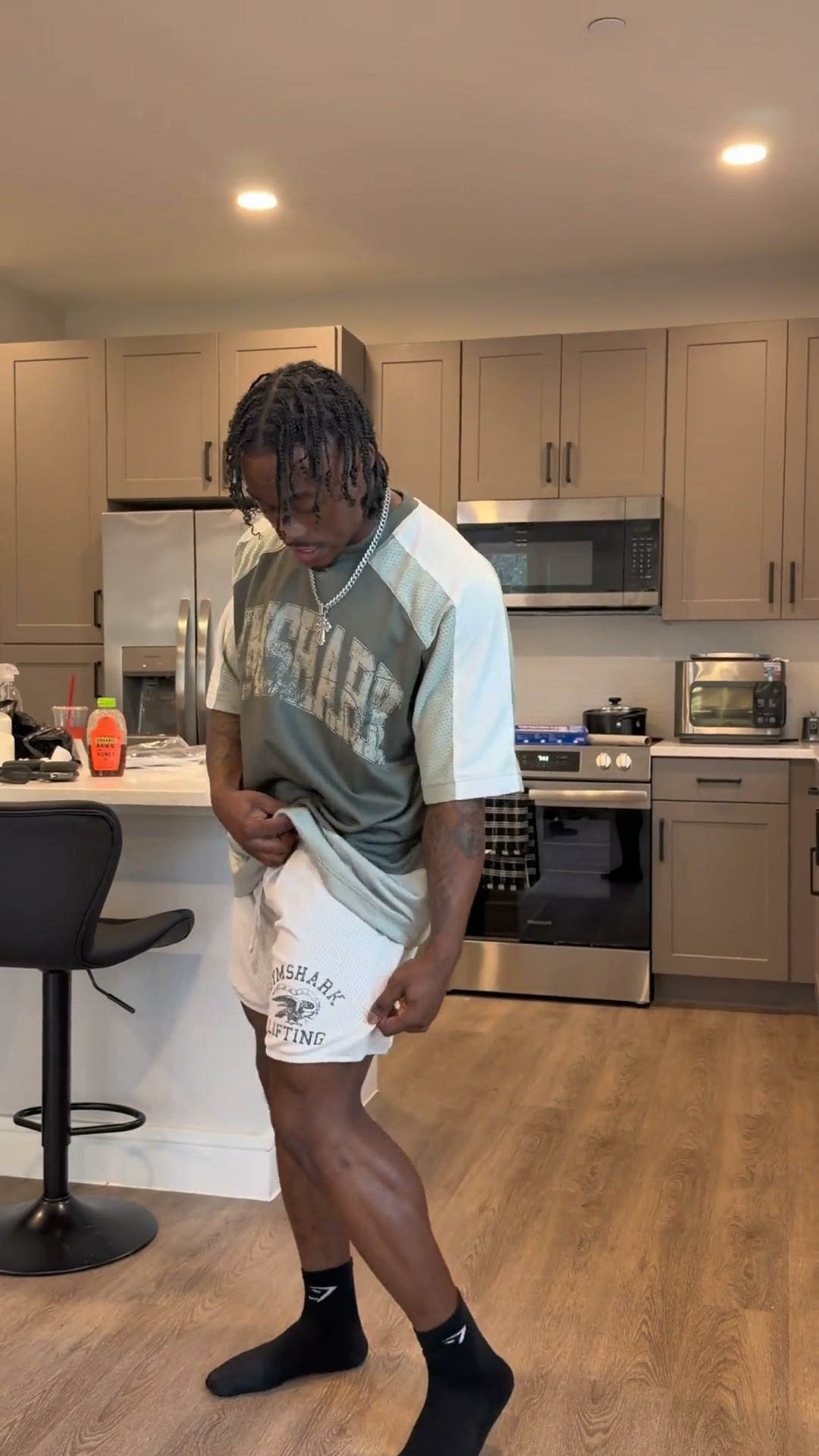 A Gymshark creator ad on Meta: a man filming a try-on of Gymshark shorts and T-shirt in his home kitchen