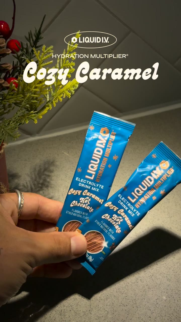 A Liquid I.V. ad on Meta: a hand holding two Cozy Caramel hot chocolate sticks