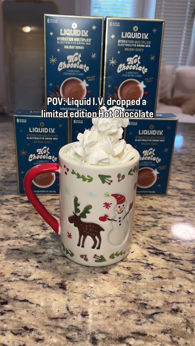 A Liquid I.V. ad on Meta: a home photo of a holiday mug with whipped cream in front of hot chocolate boxes, captioned POV: Liquid I.V. dropped a limited edition Hot Chocolate