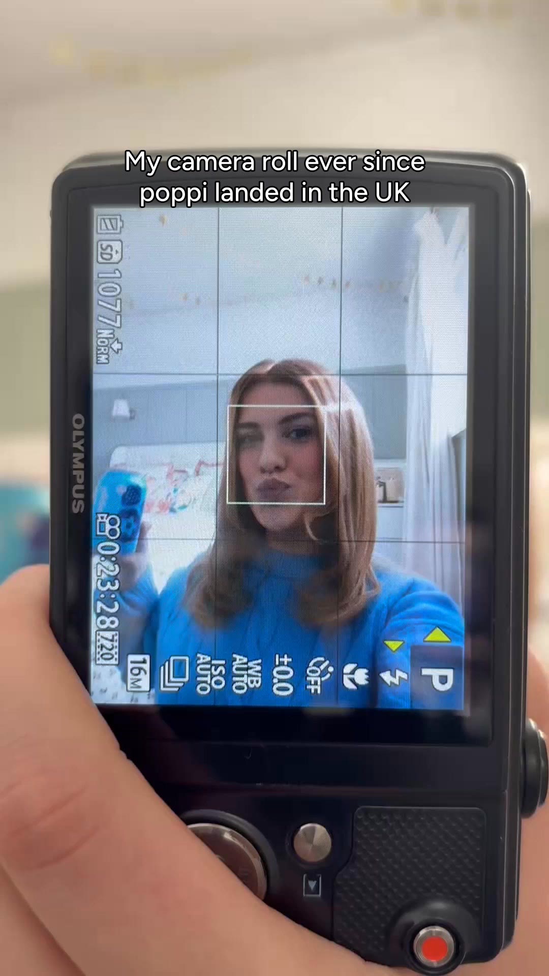 A Poppi video ad on Meta: a hand holds up a phone showing a creator filming herself, captioned Camera roll of dreams