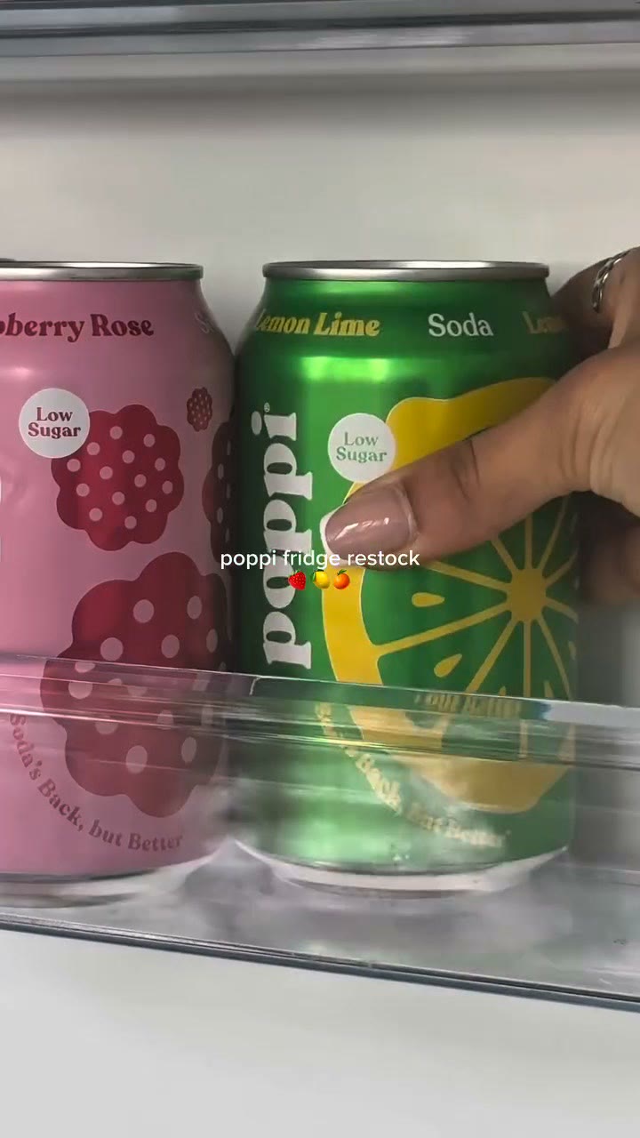 A Poppi video ad on Meta: a phone shot of a hand taking a can of Poppi from a stocked fridge