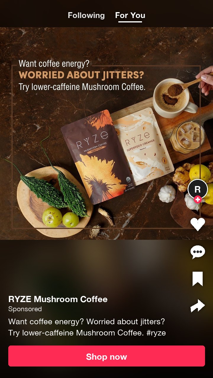 The RYZE mushroom coffee ad as a TikTok Spark Ad, its caption on two lines under 100 characters with one hashtag and a Shop now button